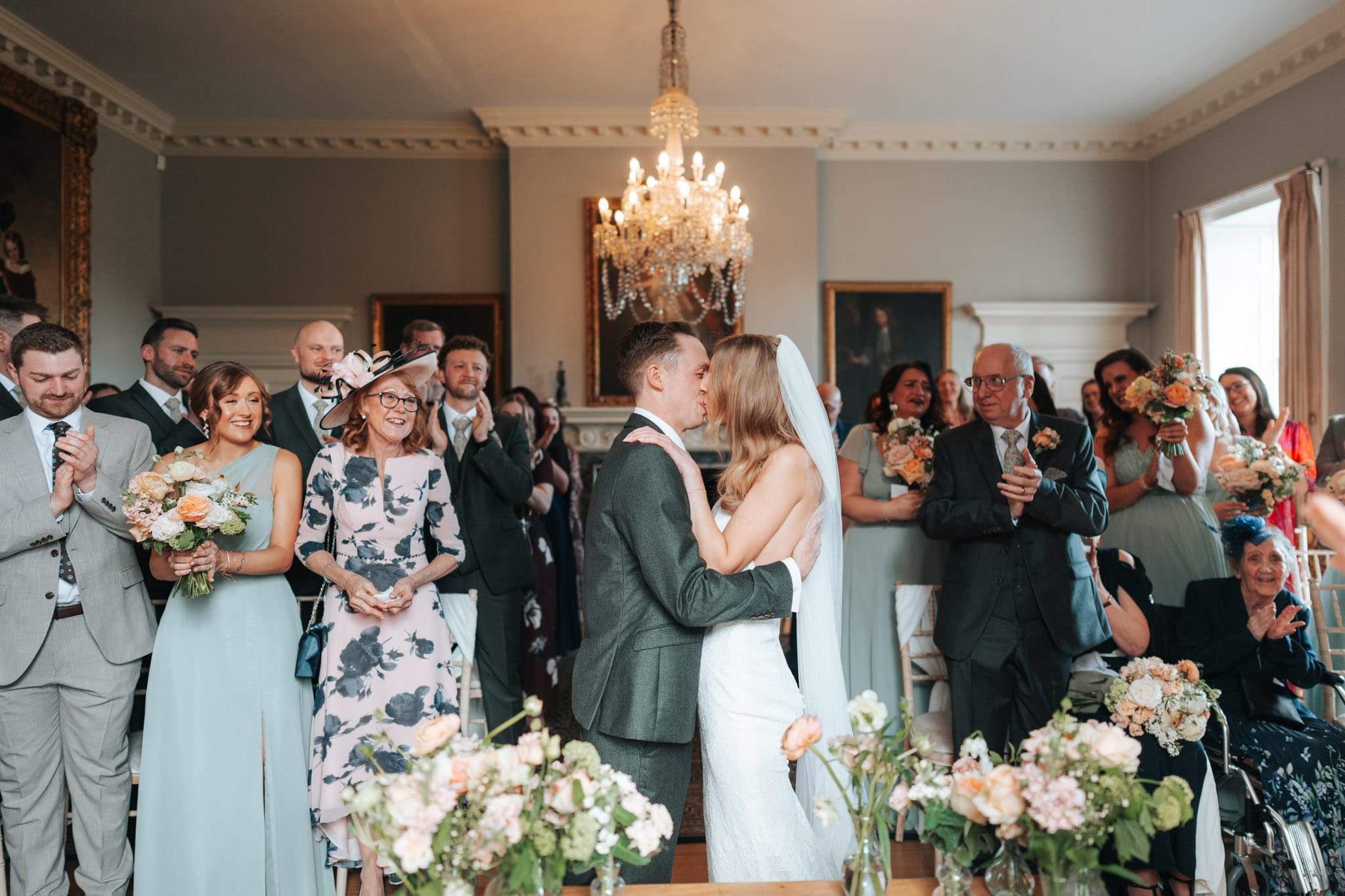A bride and groom share their first kiss at their wedding ceremony, in Norwood Park